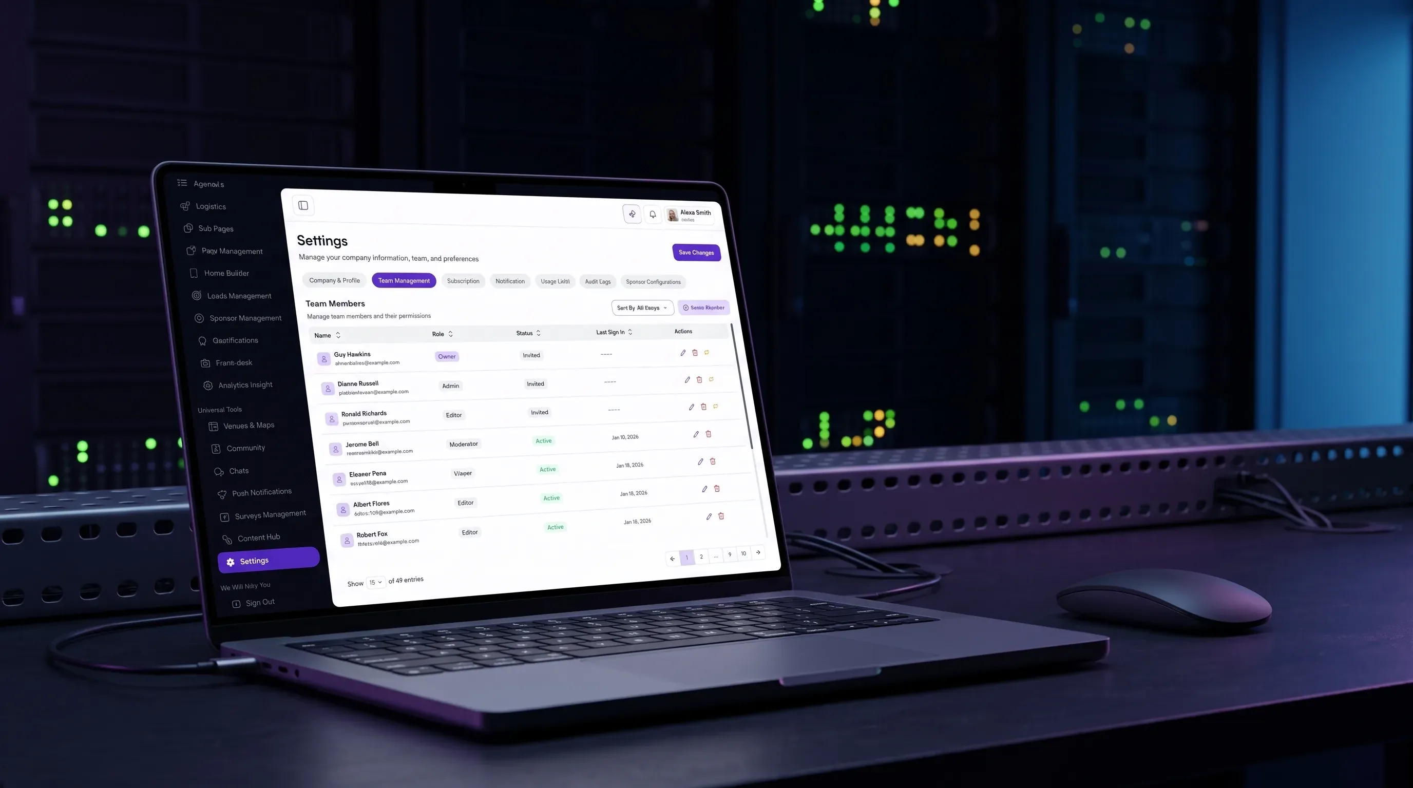A laptop showing team roles and permissions in the eBrainGo admin dashboard